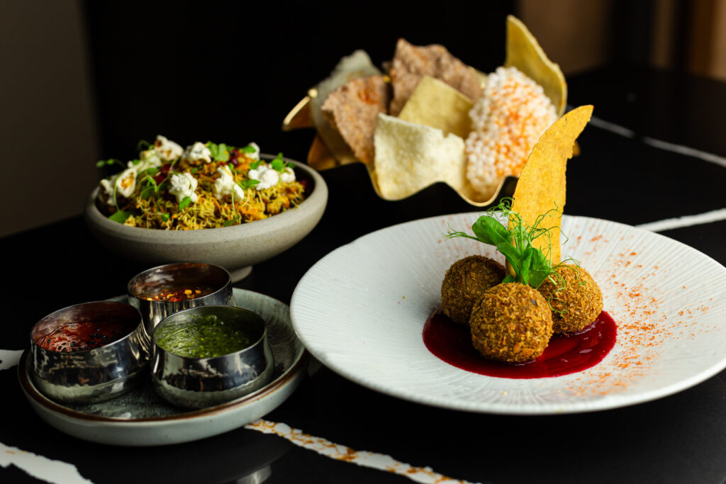Plated course with chutneys on black marble at Chatora City